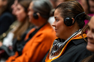  a set of headphones for simultaneous translation during negotiations in foreign languages. woman headphones used for simultaneous translation equipment simultaneous interpretation  - obrazy, fototapety, plakaty