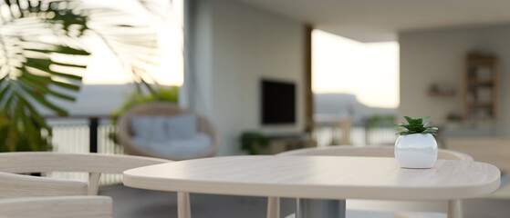 An empty space on a wooden table with a blurred modern bright living room in the background.