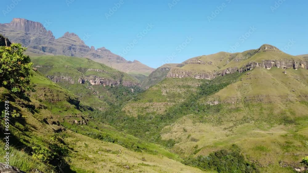 Wall mural Panning view of the Drakensberg mountains with lush vegetation of summer, South Africa