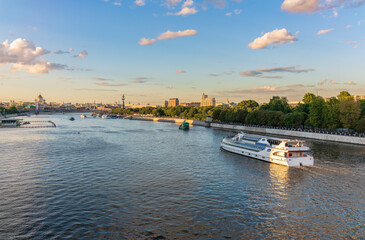 Fototapeta premium Cruise ship sails on the Moscow river in Moscow city center, popular place for walking.