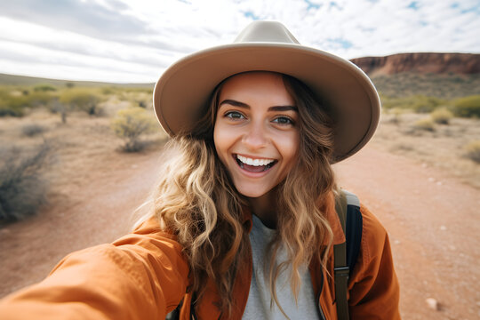 Happy traveller woman with backpack taking selfie picture in desert - Travel blogger taking self portrait with smart mobile phone device outside - Life style and technology concept