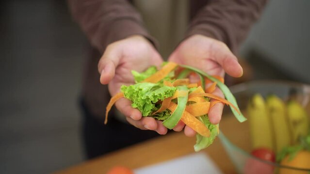 Ecology compost supply Kitchen waste sorting waste vegetable peels to recycle composter environmentally friendly. Man throws leftover fruit peel and vegetables reduce zero waste.