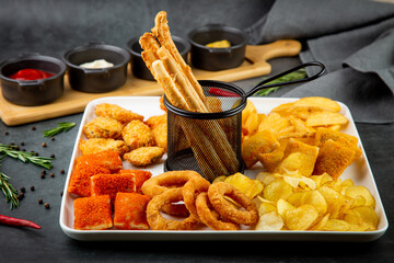 beer set with nuggets, breaded onion rings, fries and sauces