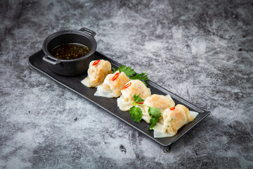 steamed dumplings with herbs, chili and soy sauce