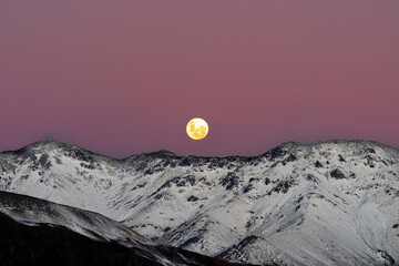a super moon rises over Mount Dobson on the shores of Lake Tekapo on June 14th 2022 -  Lake Tekapo, Mackenzie Basin, New Zealand.