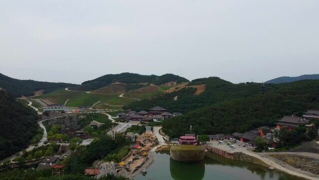 suspension glass bridge at Huaxiacheng theme park in Weihai China aerial panoramic view