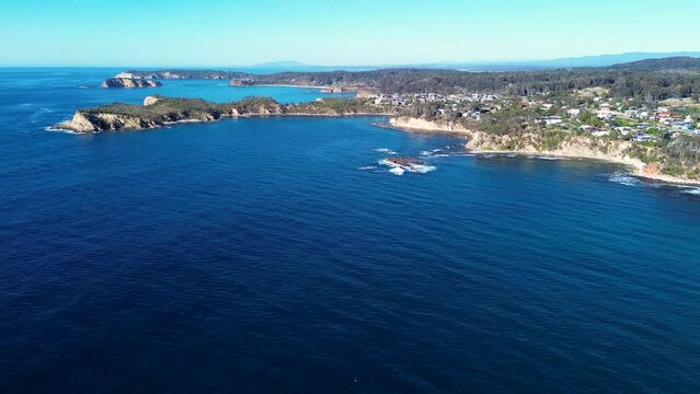 Drone aerial scenic landscape view sea ocean bay coastline headland rocky hills housing suburb Malua Bay Batemans Bay NSW South Coast Broulee Australia