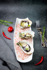 Grilled oysters on red sea salt with lime
