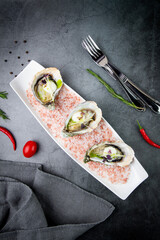 Grilled oysters on red sea salt with lime