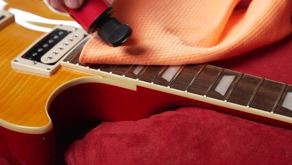 the technician setting up the electric guitar in the workshop 