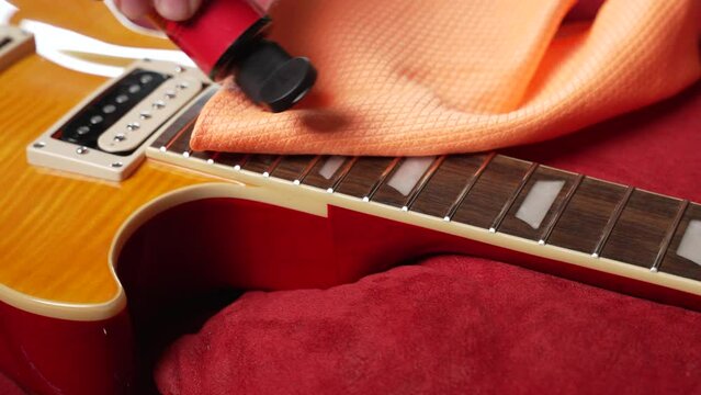 the technician setting up the electric guitar in the workshop 