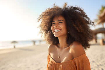 Happy beautiful young black woman smiling at the beach
