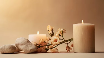 Fototapete Spa Burning candle on beige background. Warm aesthetic composition with stones and dry flowers. Home comfort, spa, relax and wellness concept. Interior decoration