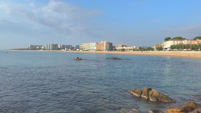 Main beach of Blanes los Pinos, views of La Palomera European tourist town