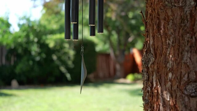 Wind chimes outside in summer in a backyard 