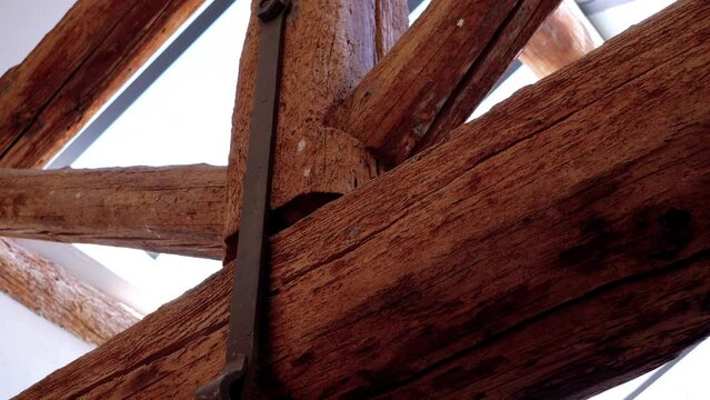 Slow orbiting shot showing the wooden structural beams within a castle in France