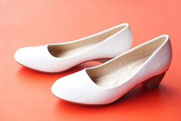 White shoes for woman on red background. Concept, fashion, formal and polite footwears for office...