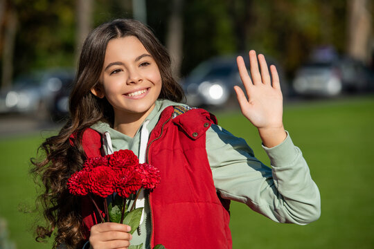 image of teen girl with fall flowers, hello. teen girl with fall flowers outdoor
