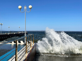 Big waves on the Sports embankment in Vladivostok in windy weather