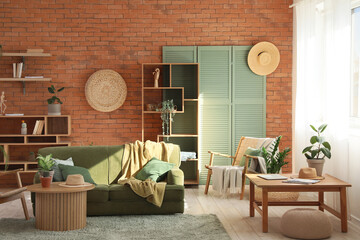 Interior of stylish living room with green sofa, armchair and coffee table