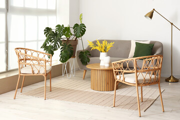 Interior of bright living room with armchairs, sofa and coffee table