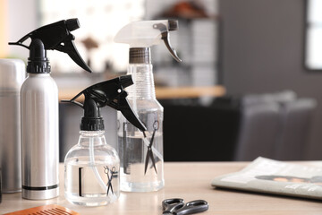 Different sprays on table in beauty salon