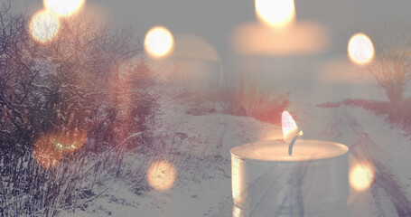 Image of candles over winter road landscape