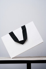 White paper bag black fabric handles on a marble - 659786293