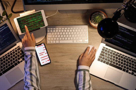 Female programmer working in office at night, top view