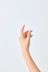 A asian woman's hand that appears to be holding a cosmetic product.