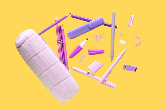 Flying pencil case and school stationery on yellow background
