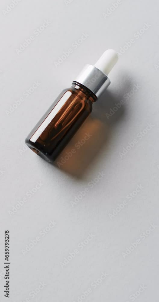 Poster vertical video of make up bottle with pipette and copy space on white background