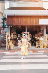 Young asian woman traveler in dress with hat traveling to wicker shop on Chang Moi Kao Road, Tourist visit at the old city in Chang Mai, Thailand. Asia Travel, Vacation and summer holiday concept