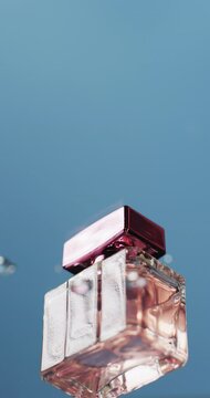 Vertical video of drops falling on beauty product bottle with copy space on blue background