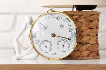 Aneroid barometer on table in room, closeup