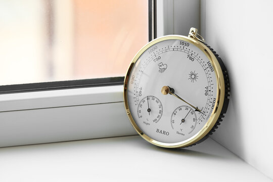 Aneroid barometer on windowsill, closeup