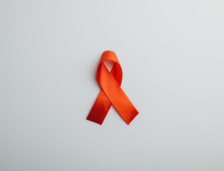 Isolated on white Red AIDS ribbon, symbol of World AIDS Day, December 1. Satin signifying...