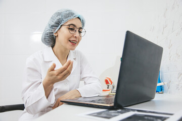 Young female doctor consulting patient via internet using laptop. Telemedicine, medical technologies, video call.