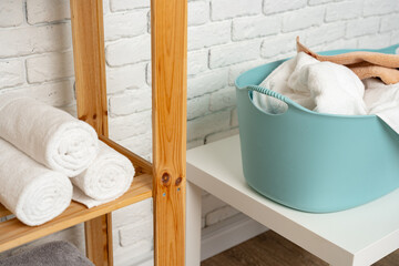 Fototapeta na wymiar Blue plastic laundry basket in a bathroom