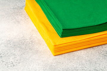 Stacks of colorful paper napkins on gray background