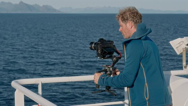 Filmmaker In Hoodie Jacket Films Ferry Journey