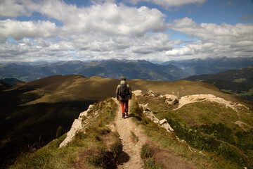 Man traveler traveling alone in breathtaking landscape of Dolomites Mounatains.