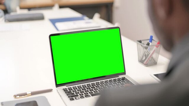 Close up of African Businessman Working on Green Screen Laptop