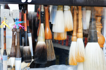 Photo of traditional Chinese writing instruments brushes for sale in a shop - obrazy, fototapety, plakaty