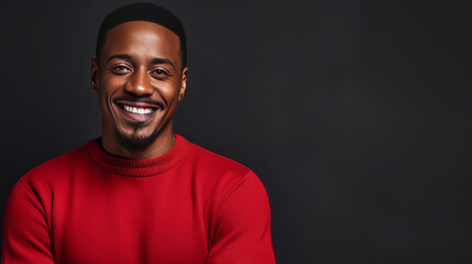 Strong black smiling African man in a red sweater on a dark background on the day of the Black Friday sale. - obrazy, fototapety, plakaty