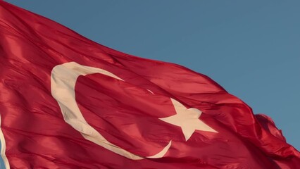 Turkish Flag or Flag of Turkiye. Waving Turkish Flag isolated on blue sky 4k video. 30 august or 29 october or 19 may or 23 april or 15 july background footage.