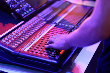 audio engineer working with sound mixing console