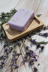 Fototapeta na wymiar Lavender soap with flowers on a vintage wooden board.