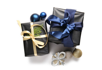 Black gift boxes with coniferous branch and Christmas balls on white background