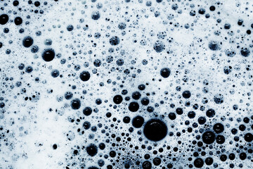 Water foam texture. White foam structure. Bubble background. Washing suds pattern. Chemical detergent backdrop. Blue foam. Suds background.